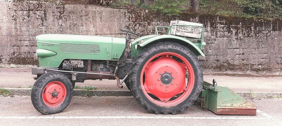 Green tractor and red wheel