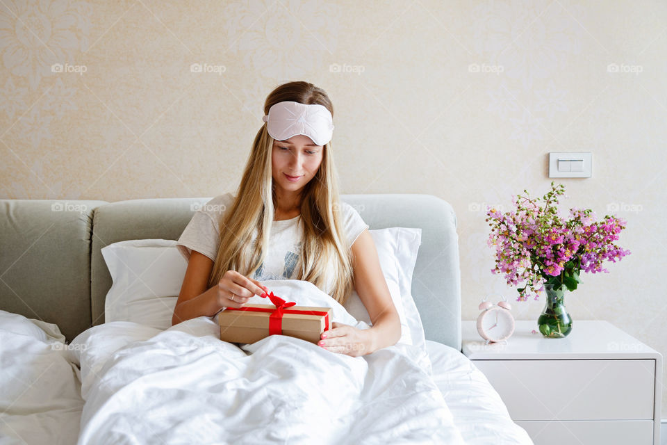 Woman unpacking gift box at home