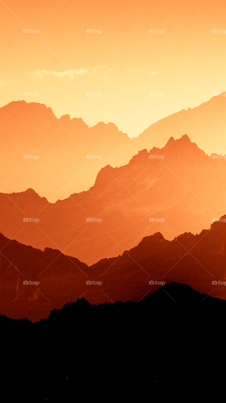 An inspiring red mountain landscape. Tatry mountains in Slovakia. A beautiful wallpaper for smartphone screen. Red abstract gradient with perspective.