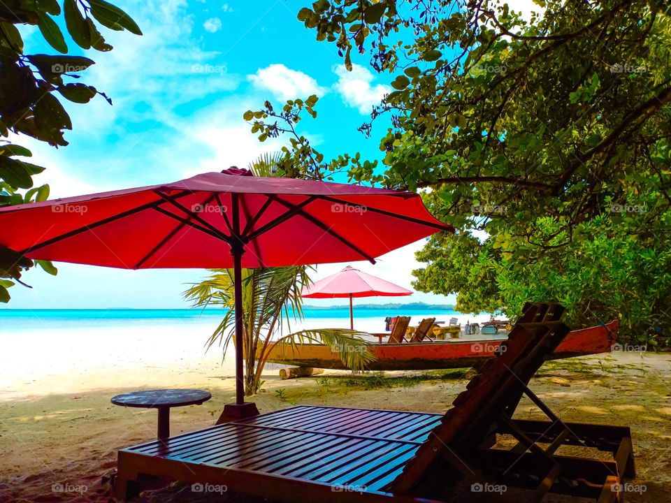Beach chairs and big umbrellas on a beautiful beach