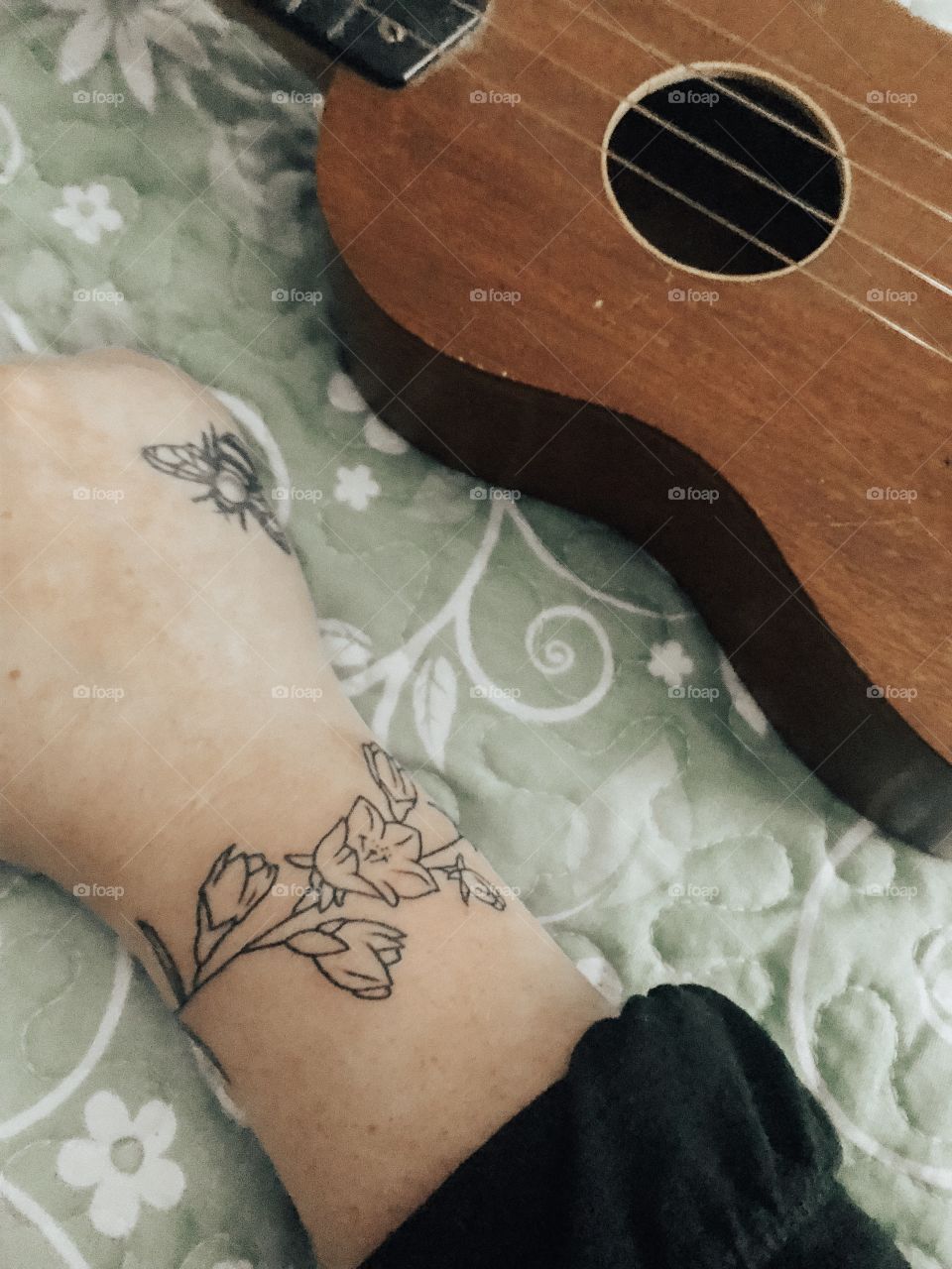 beautiful bee and flower tattoos by a ukelele