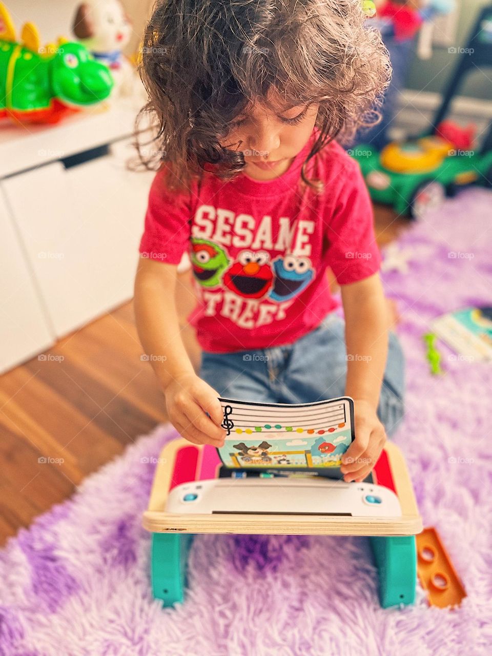 Toddlers playing instruments, toddler girl puts sheet music on piano, toddler girl plays piano, toddler plays Einstein Piano, putting sheet music on the piano, small piano for children, child learning music instrument, child using musical instrument 