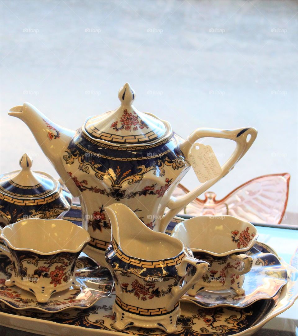 This antique tea set shows a lovely still life that invites the viewer to reach out and grab the handle of the teapot.