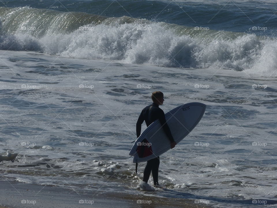 Surfer entering the surf