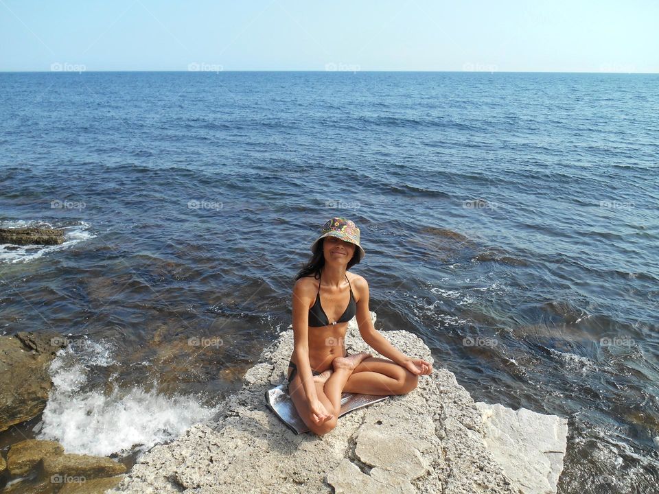 happy woman meditation on a sea shore