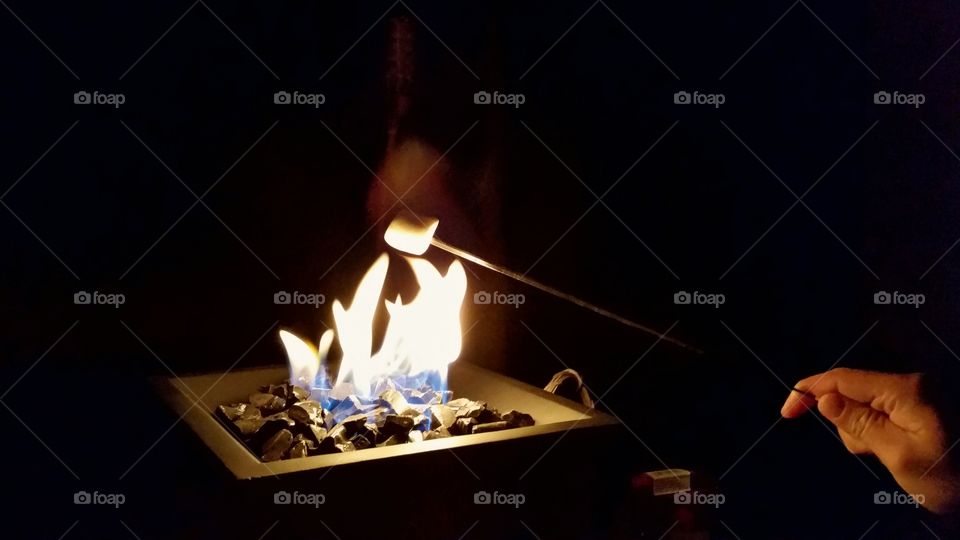 marshmallows roasting on an open fire
