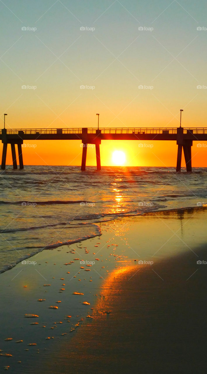 Sunset under the pier!
Stunning sunset in the Gulf of Mexico radiating explosive sun rays across the ocean and sandy beach!