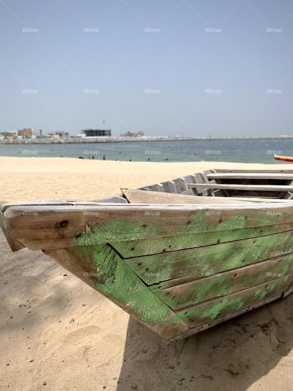 Wooden boat placed on the sand of a beach