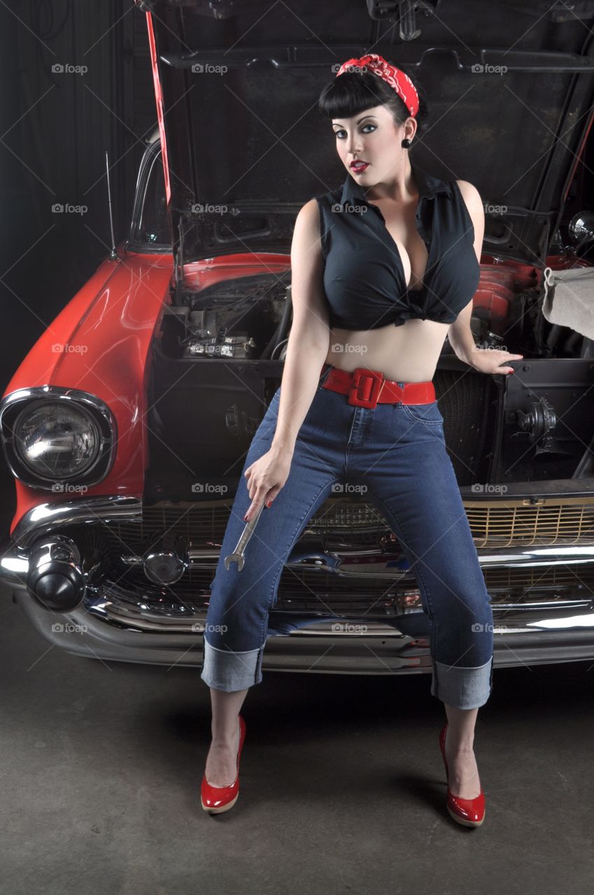 Portrait of a young woman in front of car