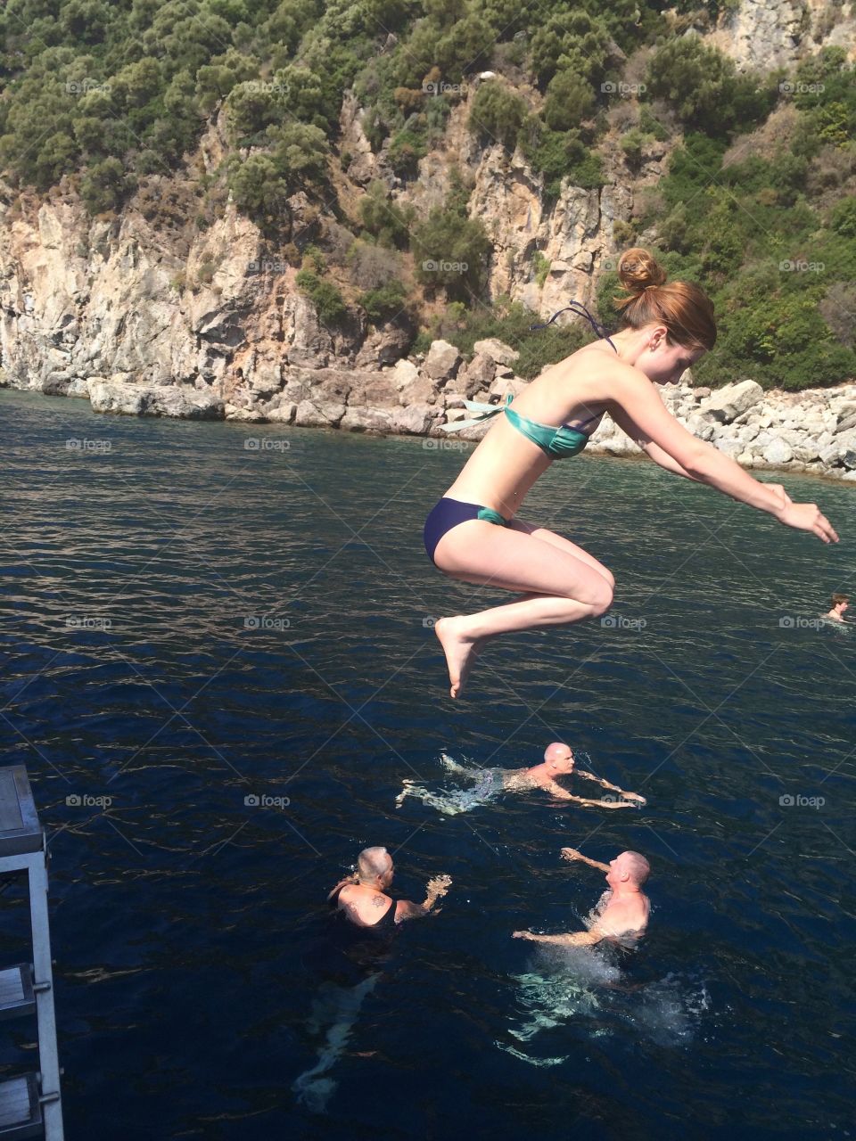 Woman jumping into the river