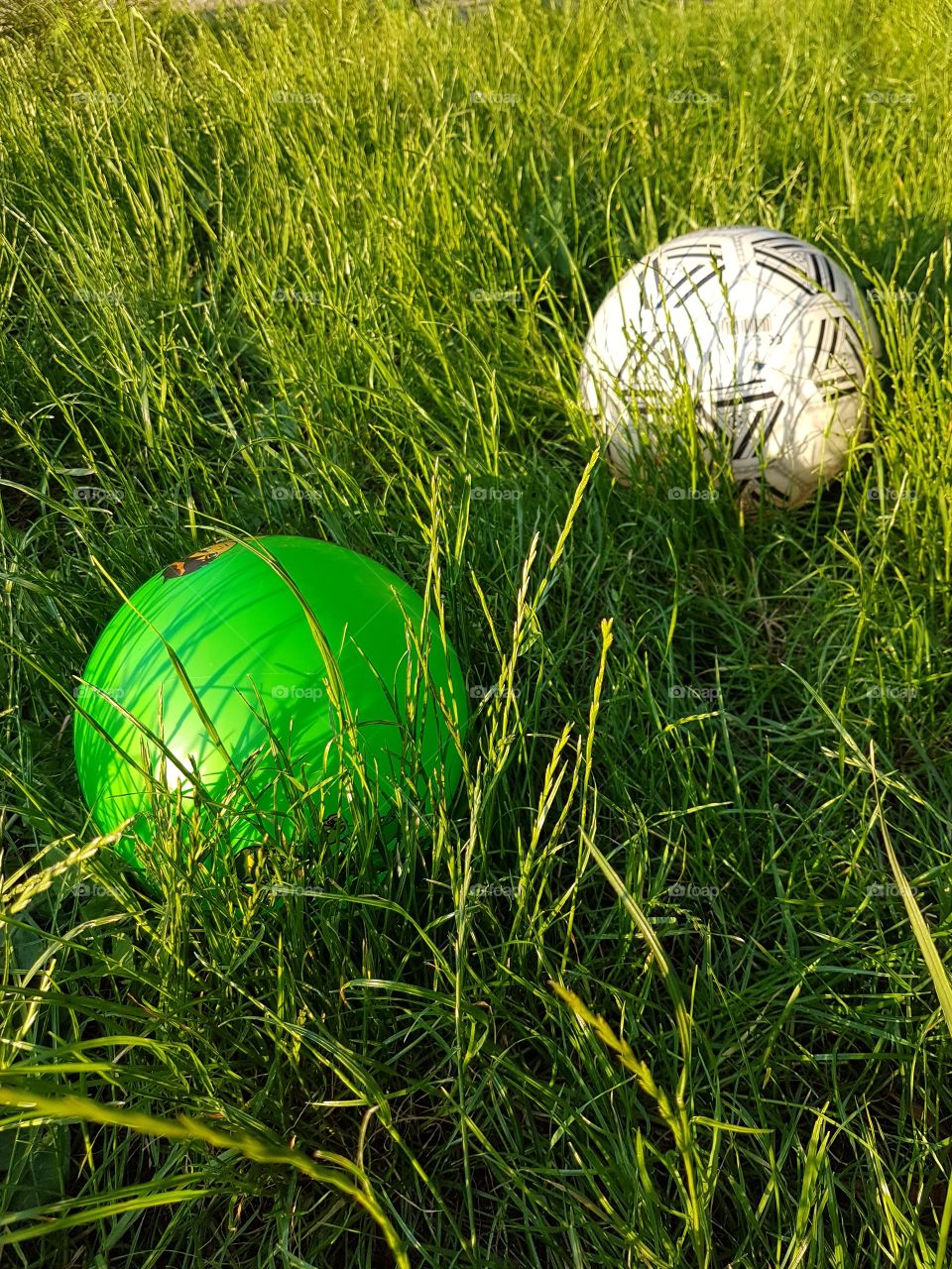kid ball in the grass on the playground