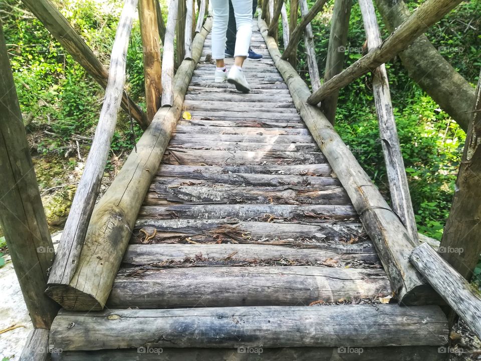 Cross a wooden bridge