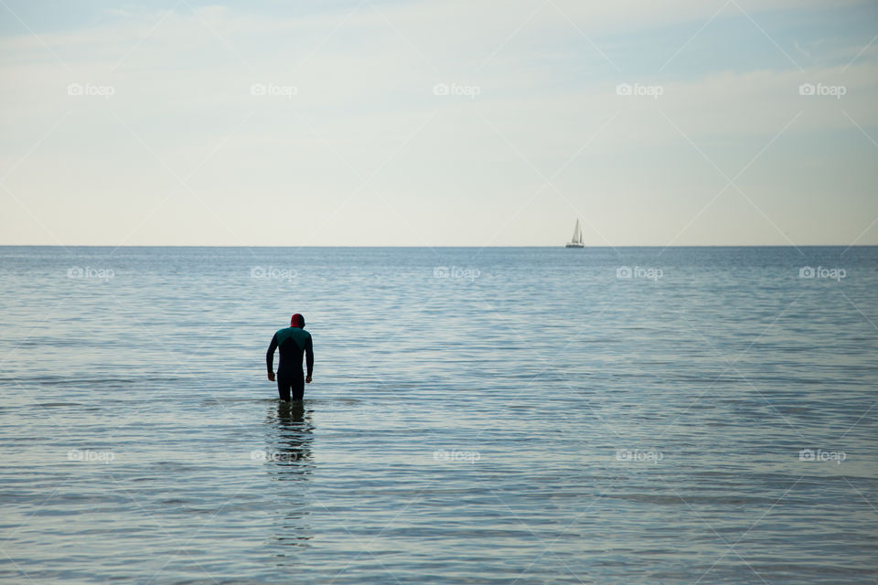 Single swimmer standing in the sea