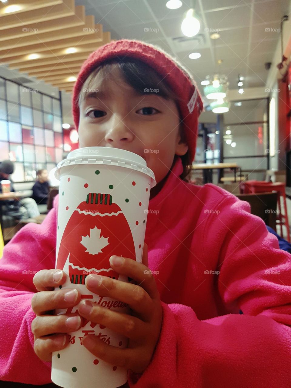 Happy girl with a cup of a hot chocolate