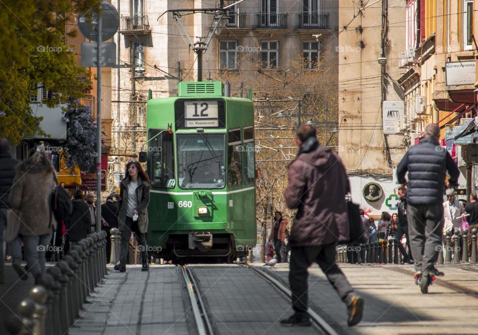 City life, tram line and people on the street