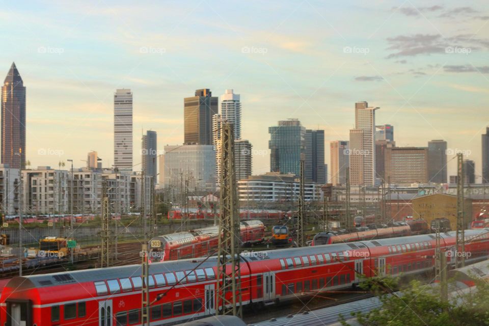 Cityscape of Frankfurt/Main with skyscrapers and train station during a train journey