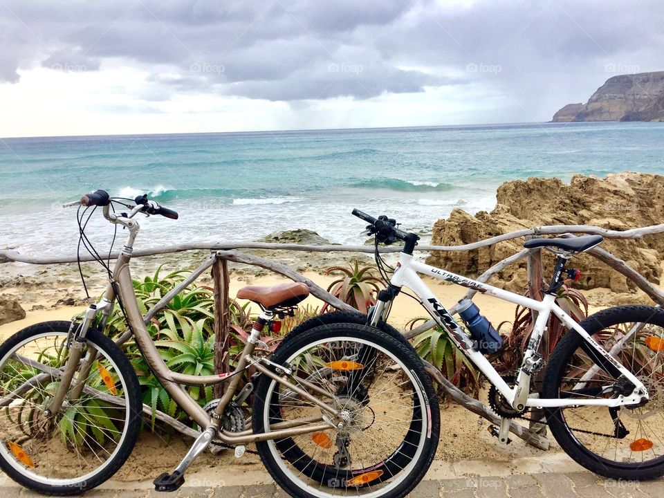 two bikes near yellow sand beach