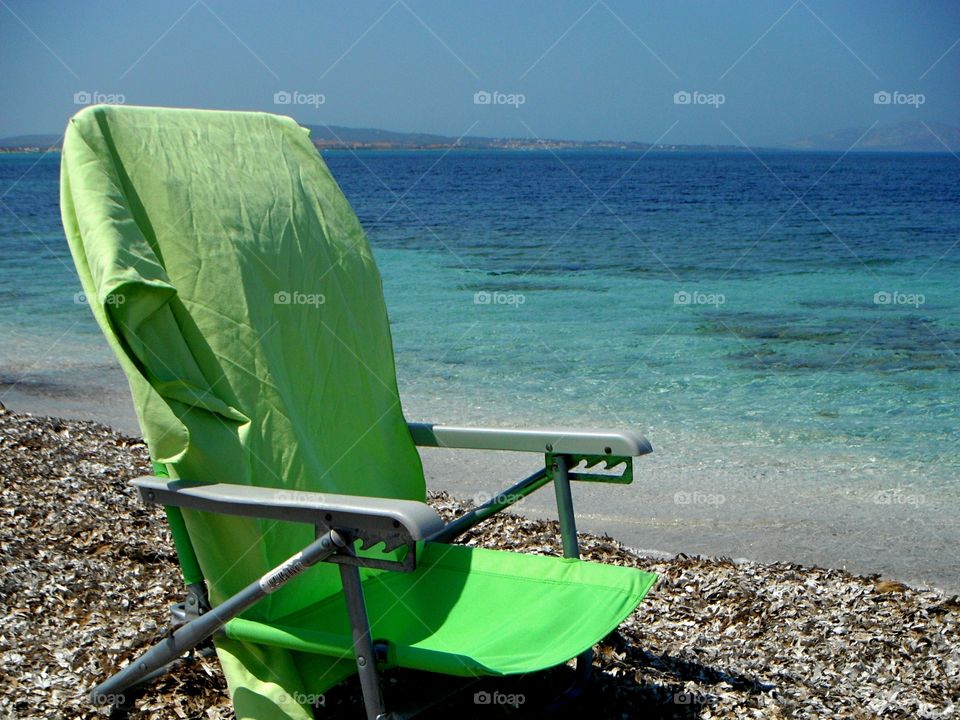 green lifestyle: sea chair in front of blue sea