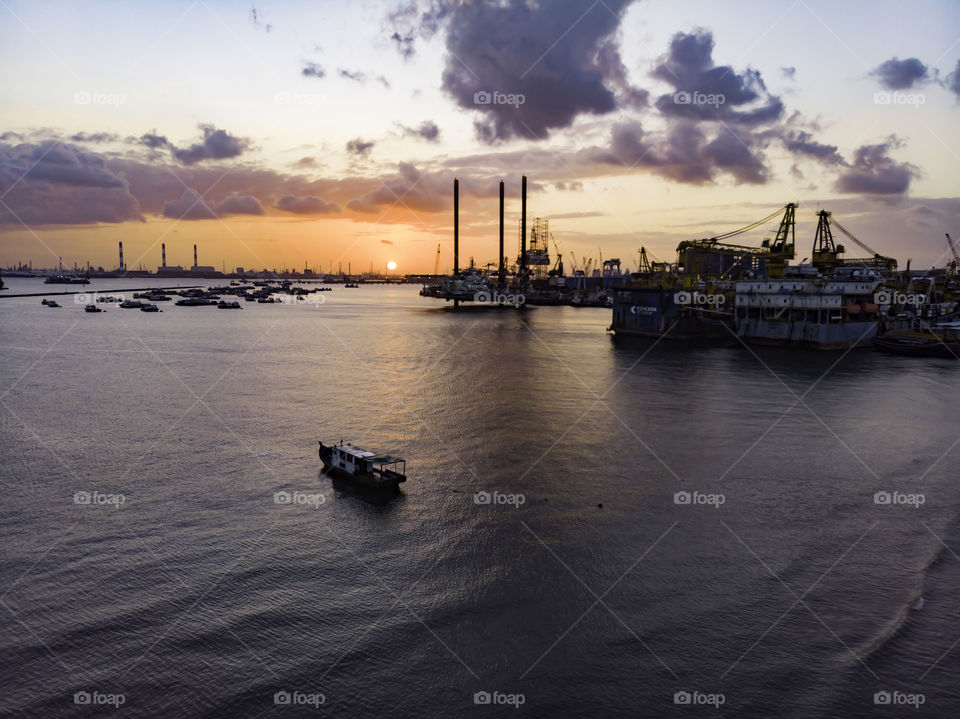Sunset by the bay with ships docking around
