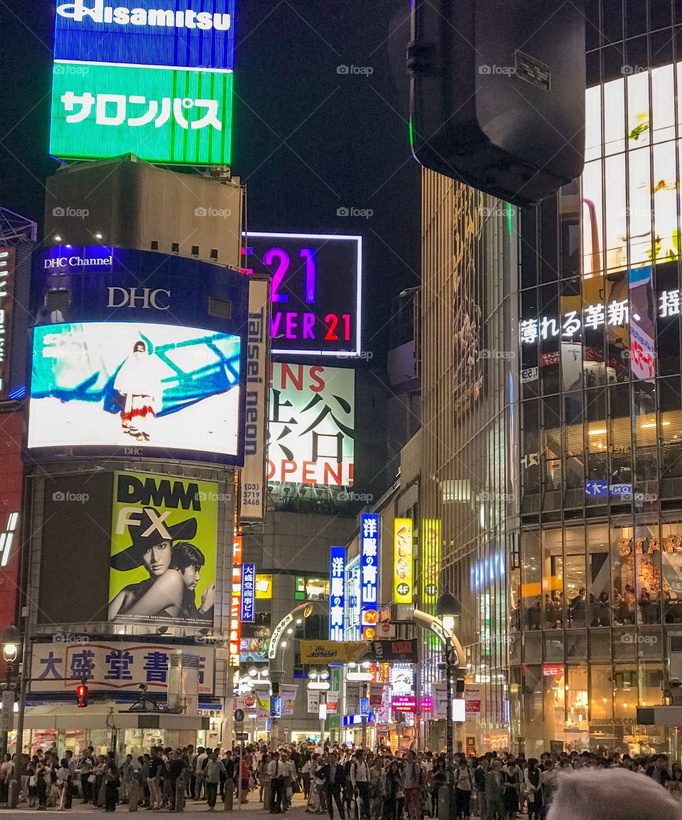 Bright neon lights trying to capture our attention; on the streets of Tokyo..