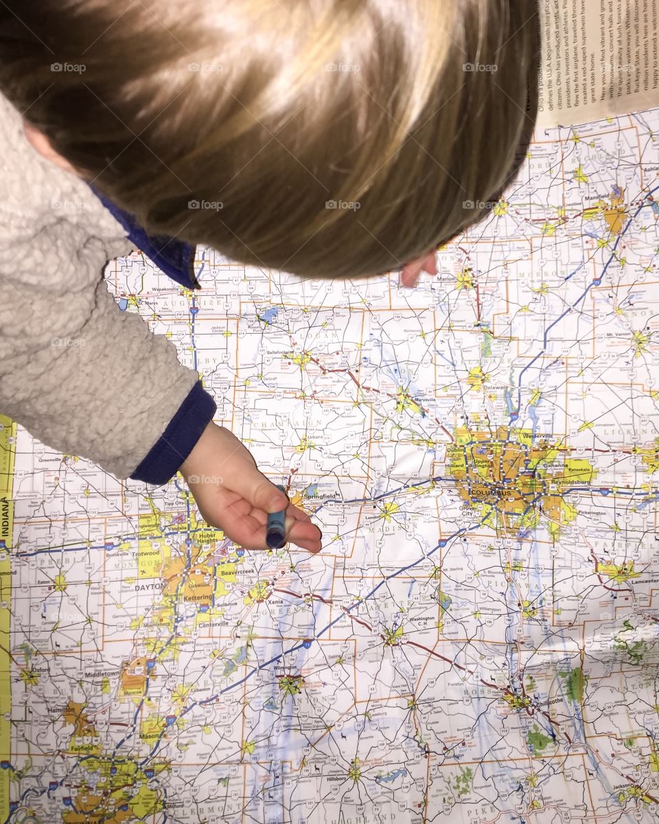19 month toddler boy drawing on road map