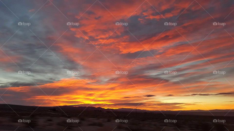 the sunrise in the desert with beautiful dark colors in the desert