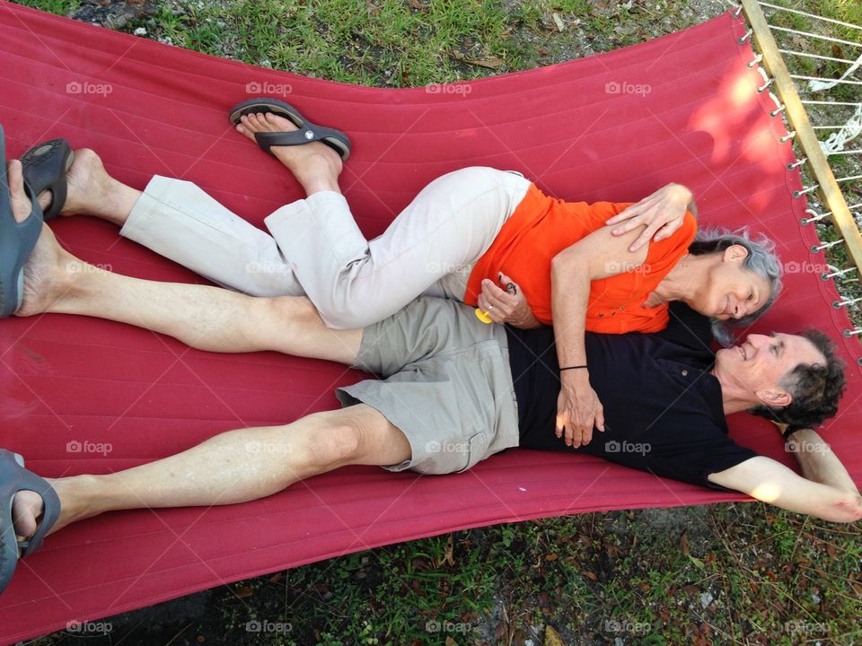 Elevated view of a mature couple lying on hammock