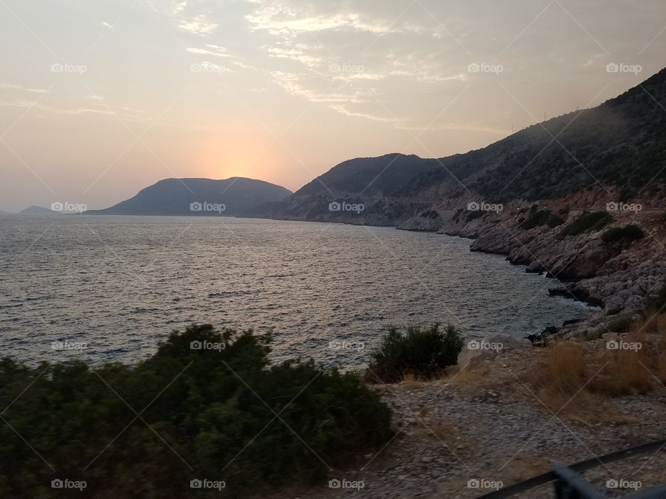 sun setting past the mountains in Kalkan Turkey