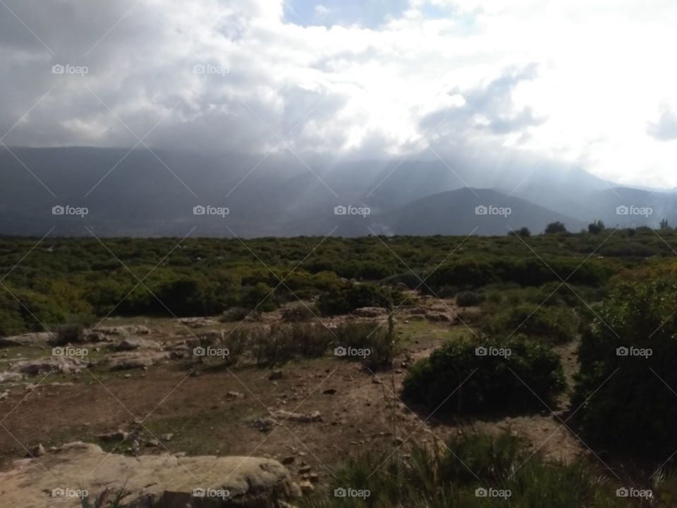 sun light through clouds on atlas mountains