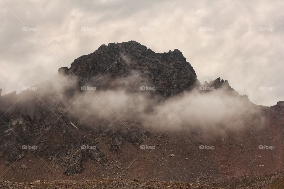 Cloud wraps around the top of the mountain.