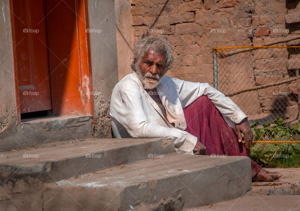 Dirty man sitting in sunny Day