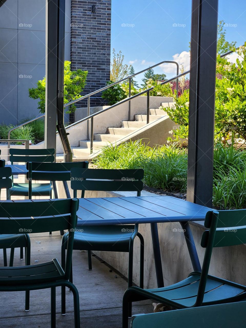 outdoor restaurant seating with view of stairs on clear day in Oregon