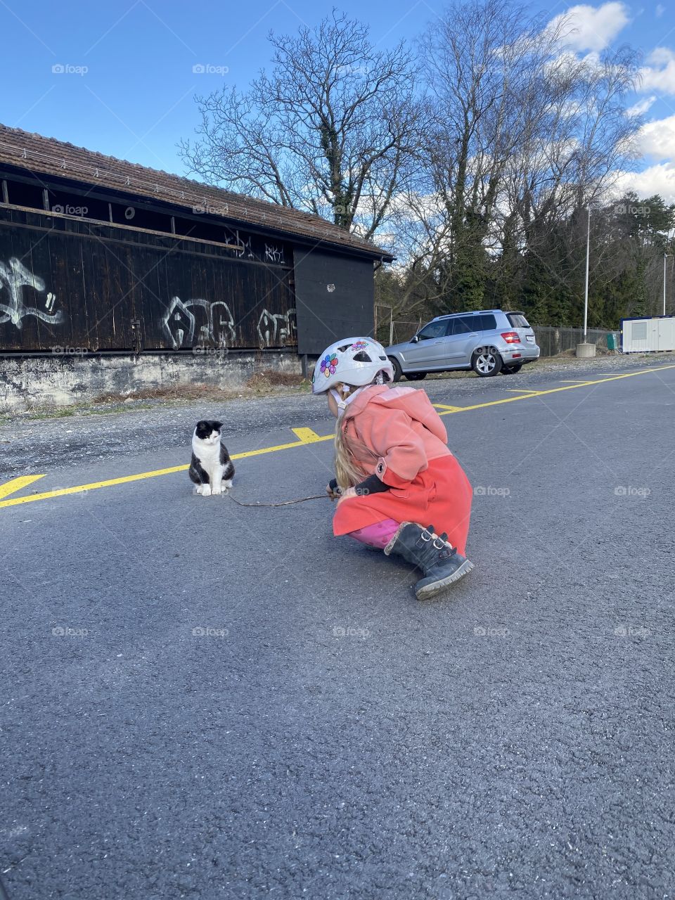 girl playing with a cat