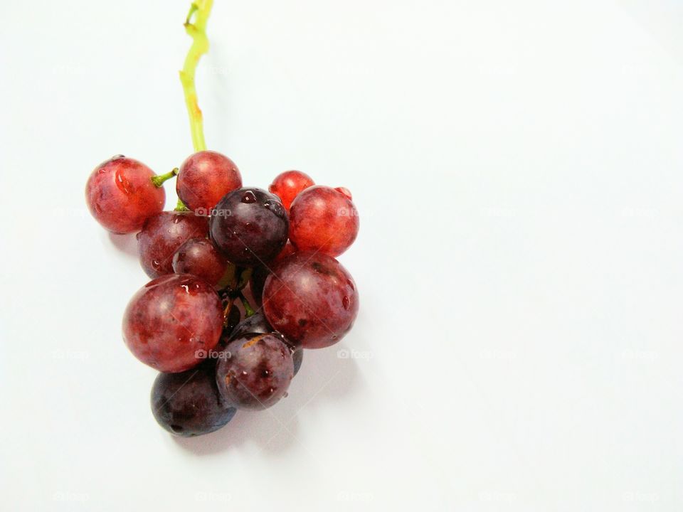 Seedless grapefruit isolated on white background.Water drop on fresh purple grape.