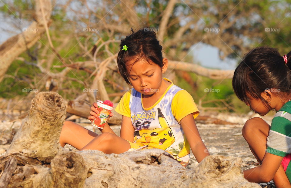 Playing together. Yellow clothing of young chinese interest to do sand for doing better as a building what in their imagination. They look for friendly along, and walking together for enjoyable of what .