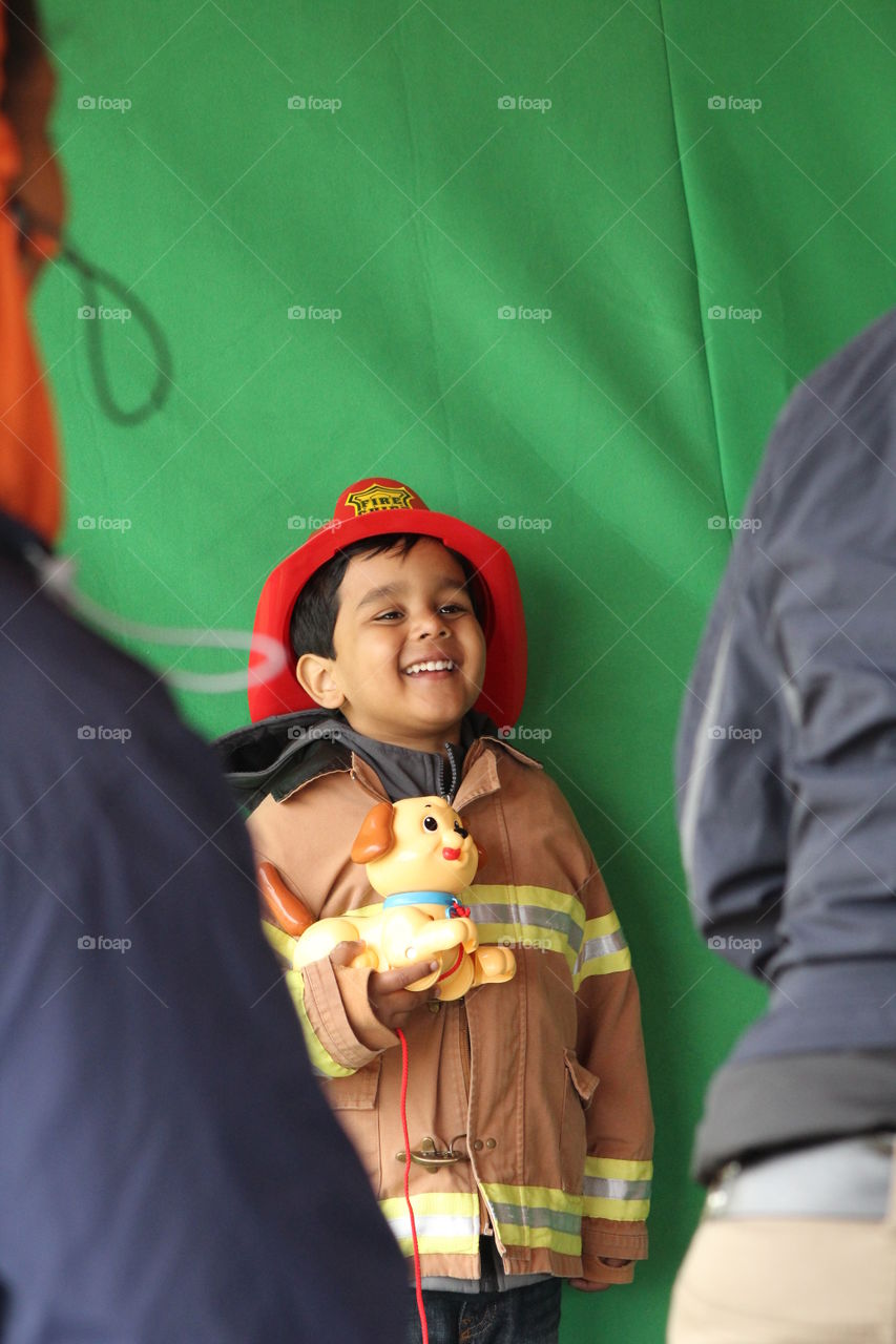 Happy kid aspiring to be fire fighter when he is grown up 