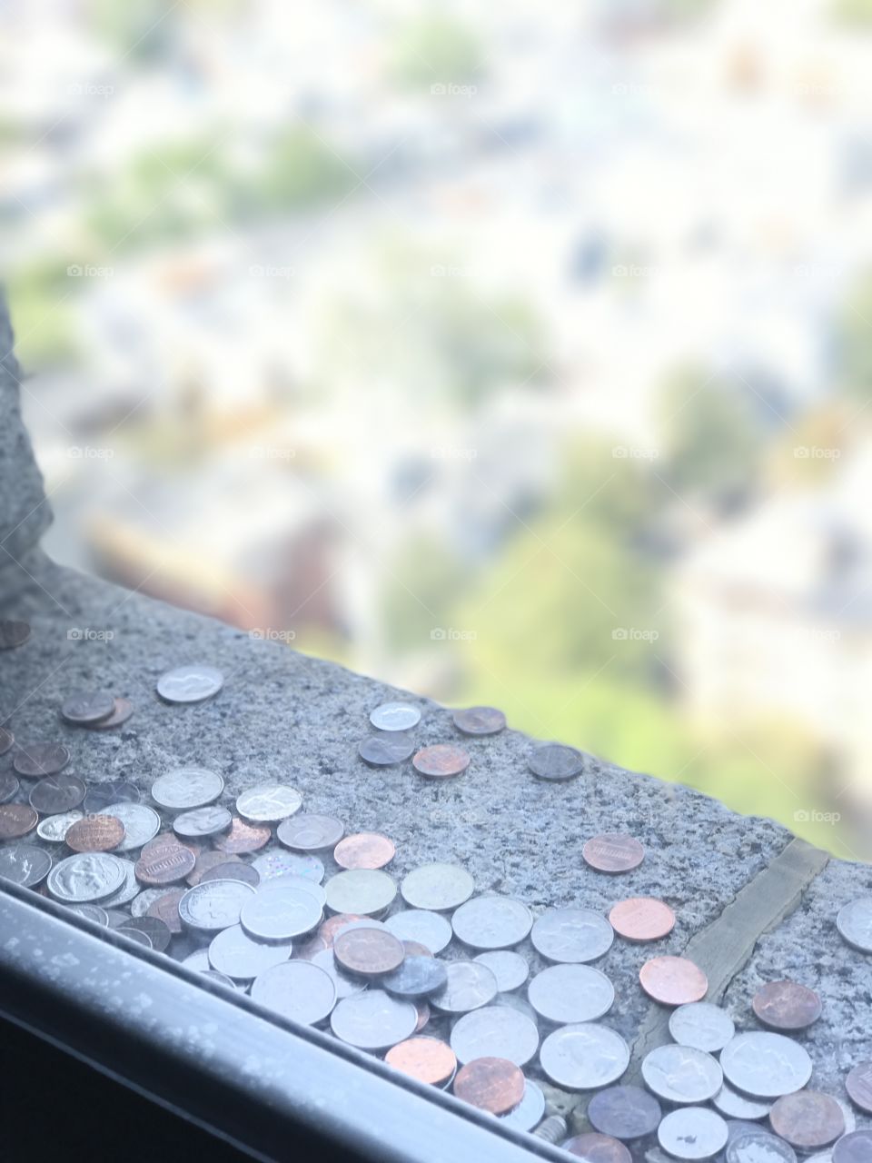 Coins sitting on the window of Bunker Hill in Boston 