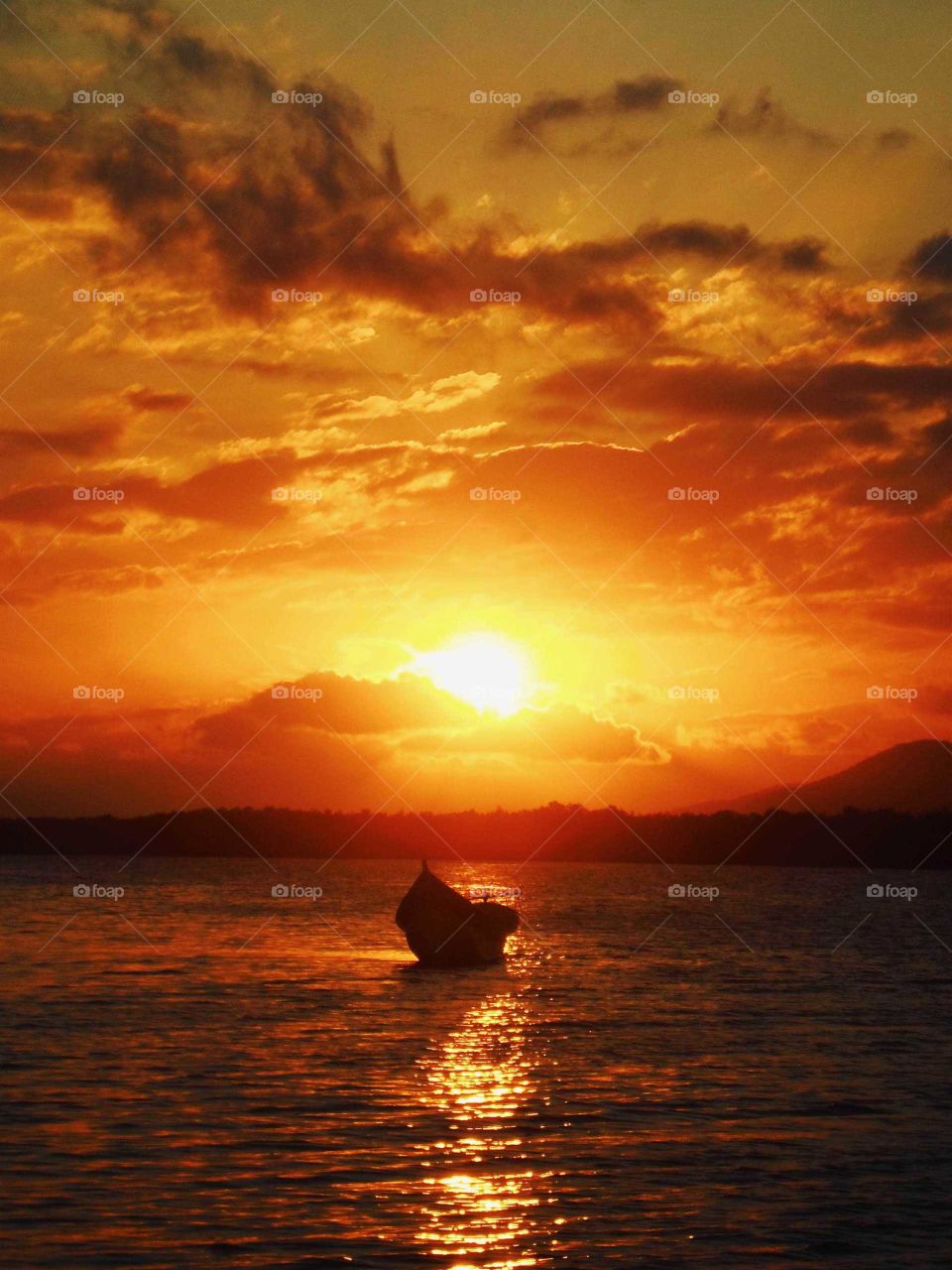 Beautiful landscape, boat at orange, red and yellow sunset. At Cardoso Island, tropical summer, Brasil lofi bossa nova vibes.