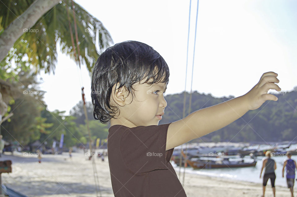 Portrait boy Sitting on the beach, Koh Lipe at Satun in Thailand.