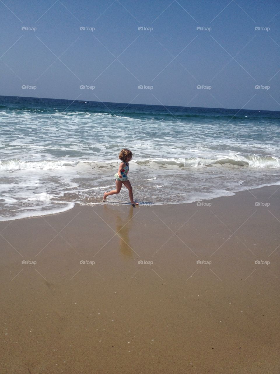Little girl playing at the beach in California 