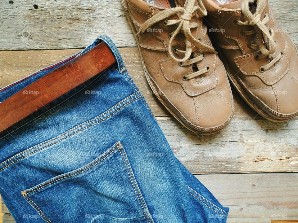 Blue jeans, leather belt with shoes