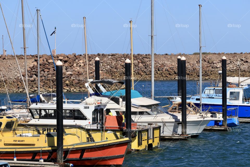 Ocean Boat marina in inner harbour surrounded by rock Jetty 