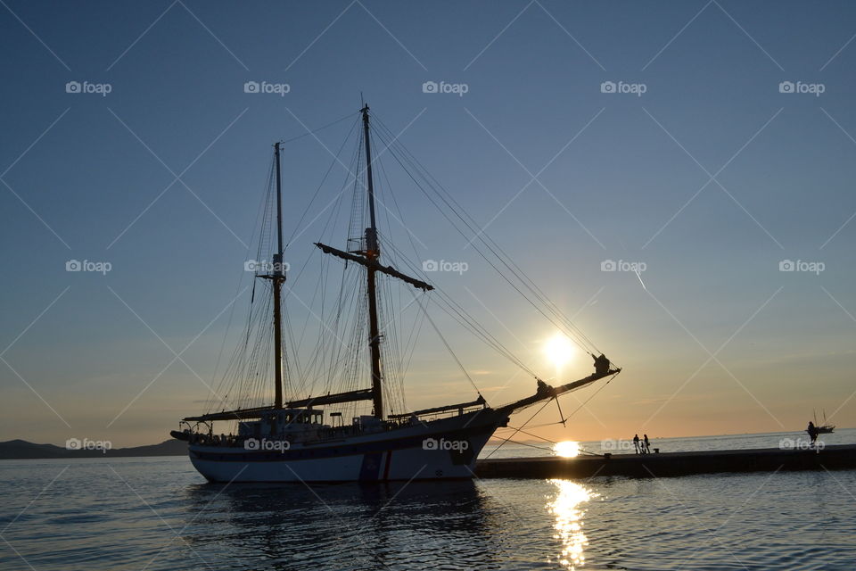 Boat silhouette by sunset