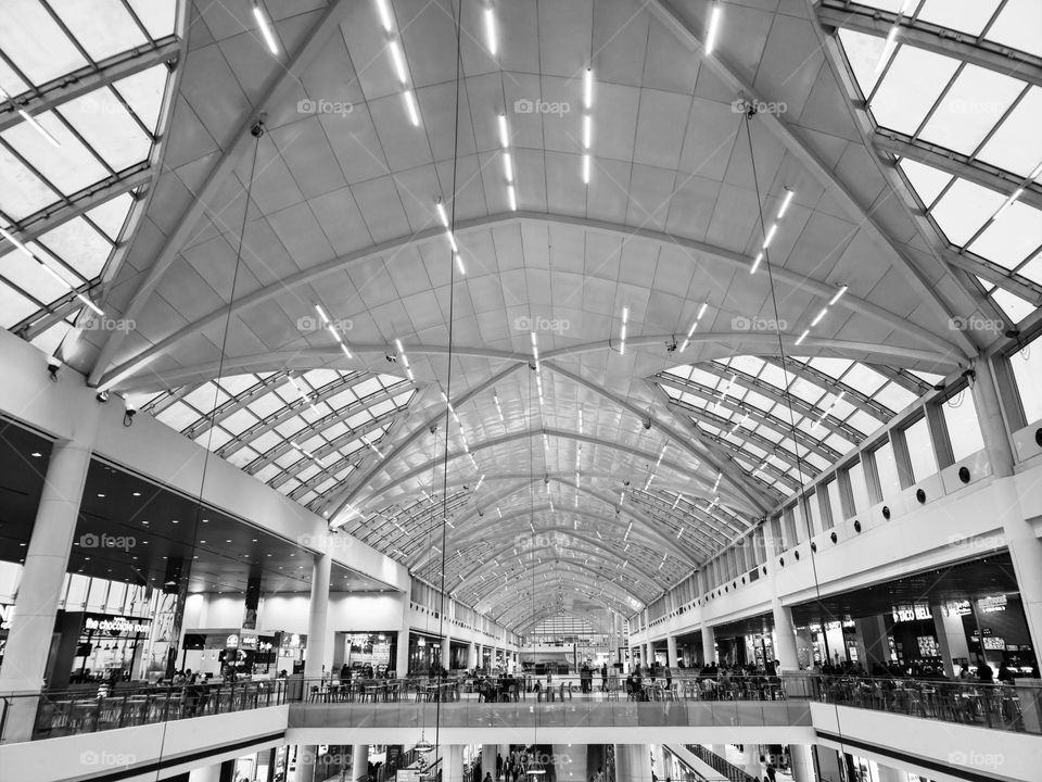 ceiling view of mall in black and white