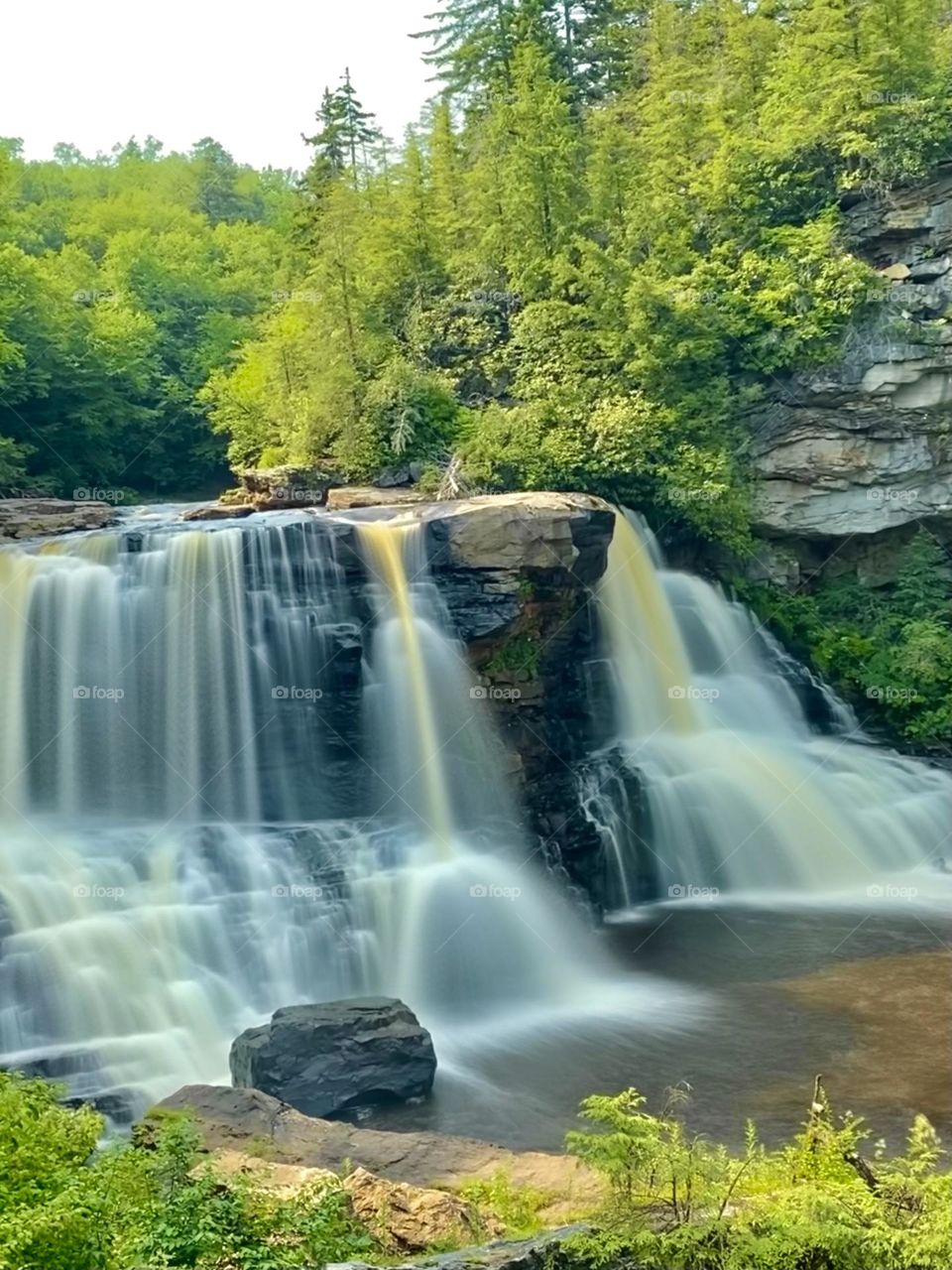 An aerial time-lapse unveils West Virginia's Black Waterfalls, cascading into the abyss. The water, a liquid shadow, flows relentlessly, creating a mesmerizing spectacle of nature's power.