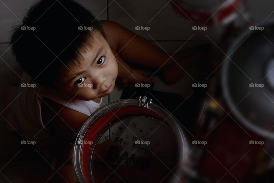 Little boy with toy drumset