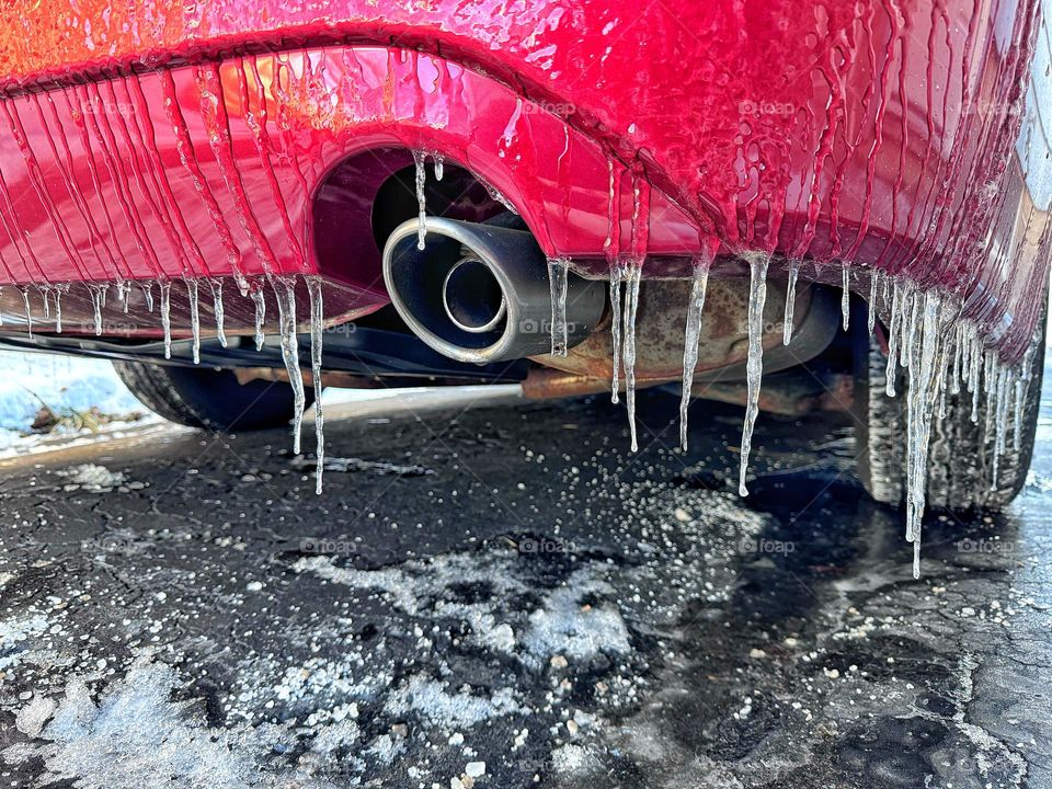 Icicles on a red car 