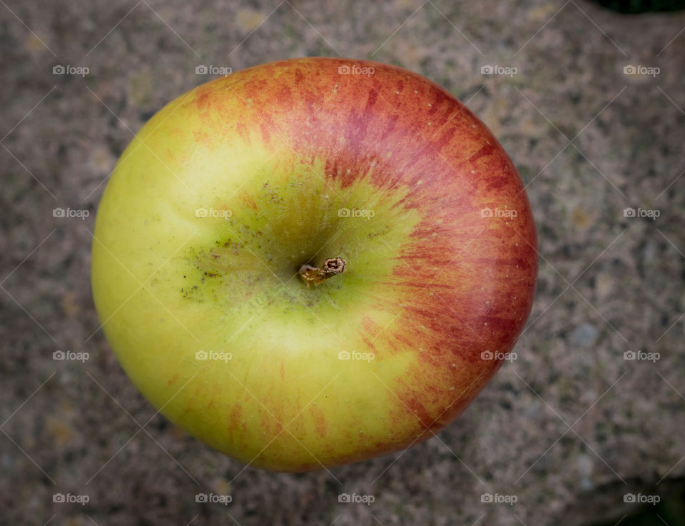 Apple close up on a stone background.