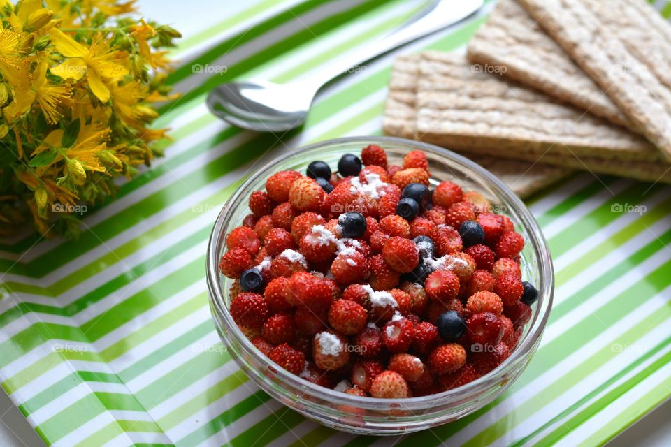 red wild strawberries on a plate tasty summer healthy food