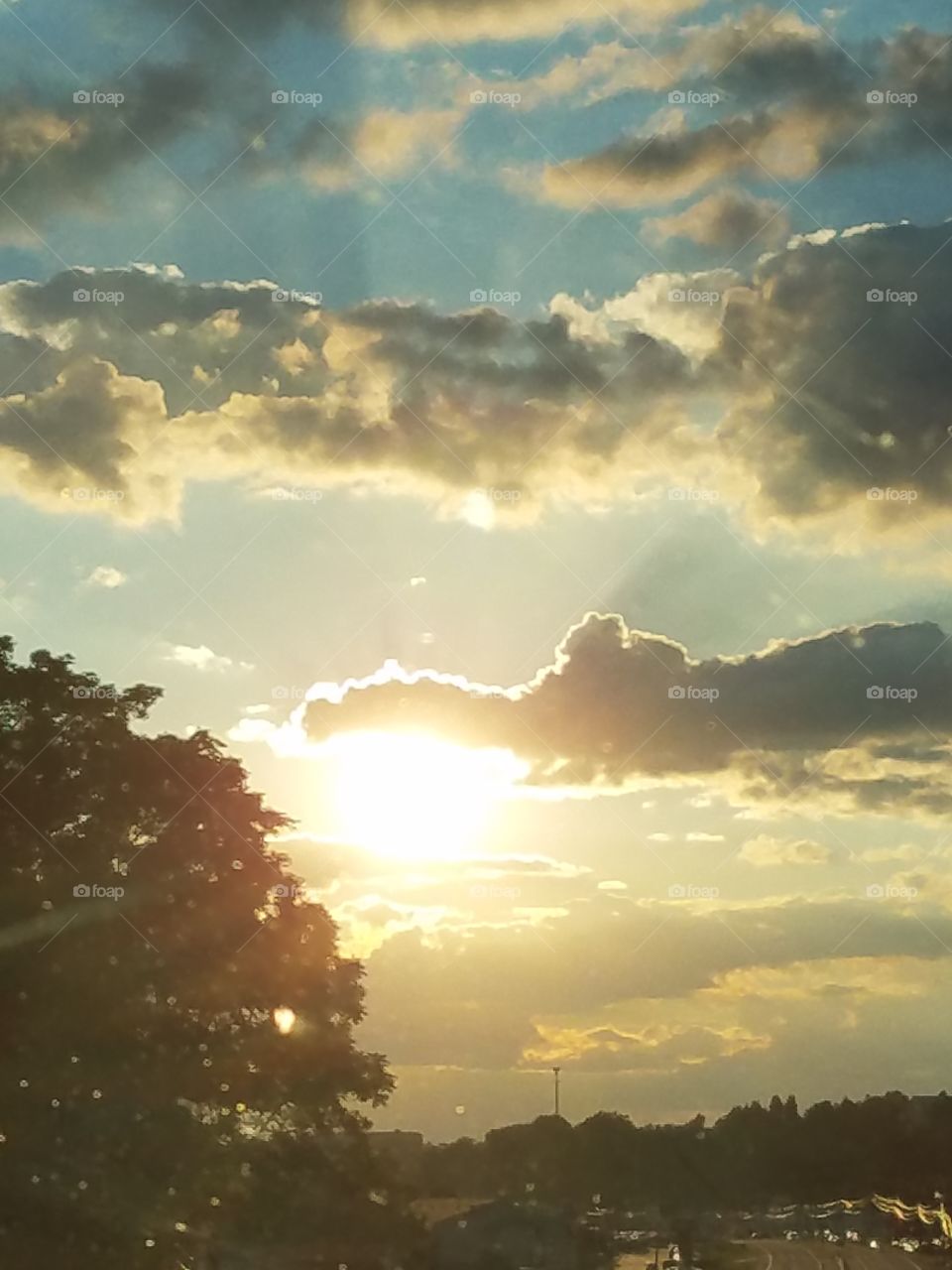 sun setting behind the clouds